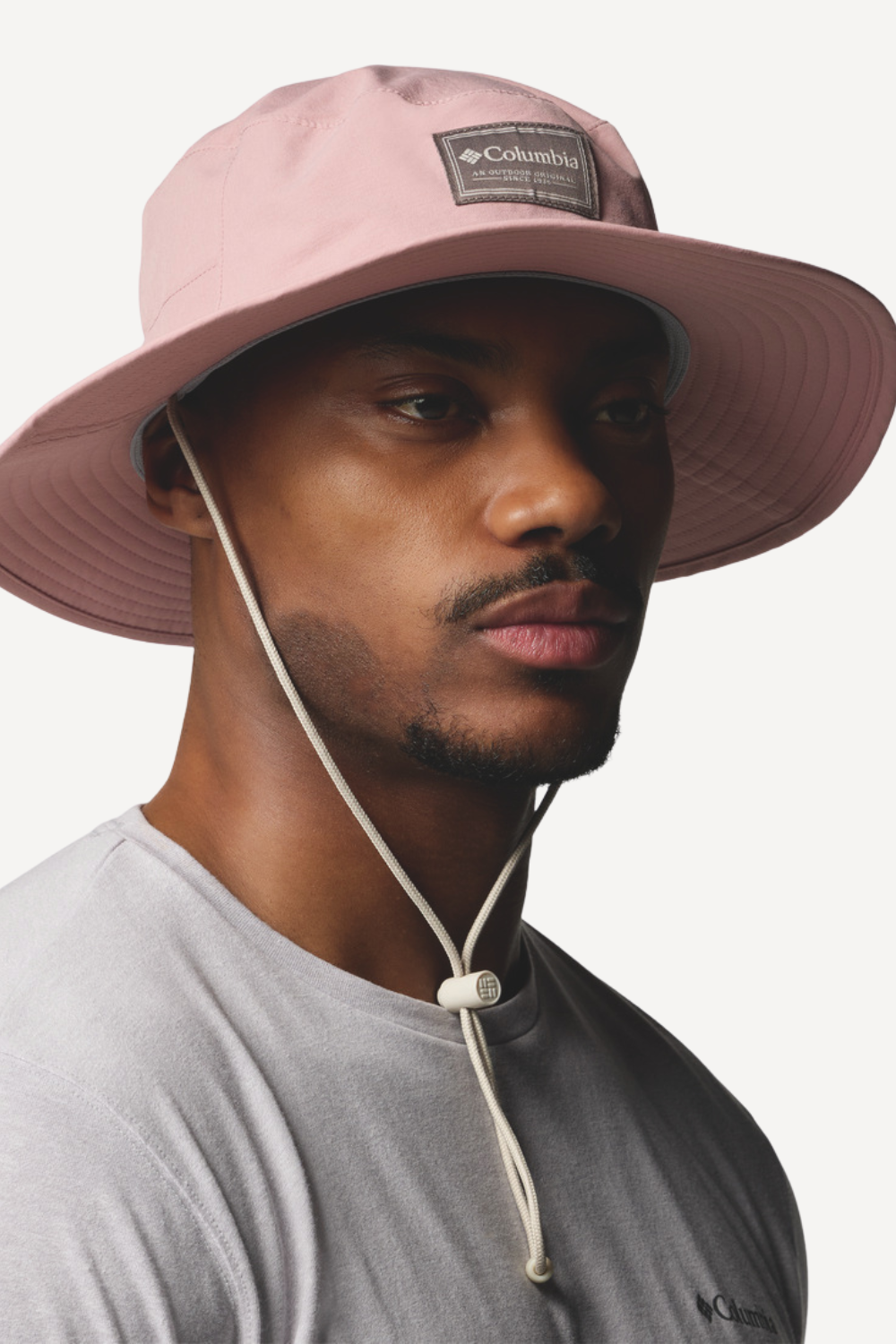 Chapeau anti-UV Columbia rose pour homme, protection solaire UPF 50+ et élégant pour les activités en extérieur.